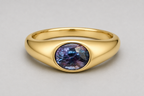 A 3D render of an oval-cut colour change sapphire flush set signet ring in a silver, shown on a neutral light grey background.