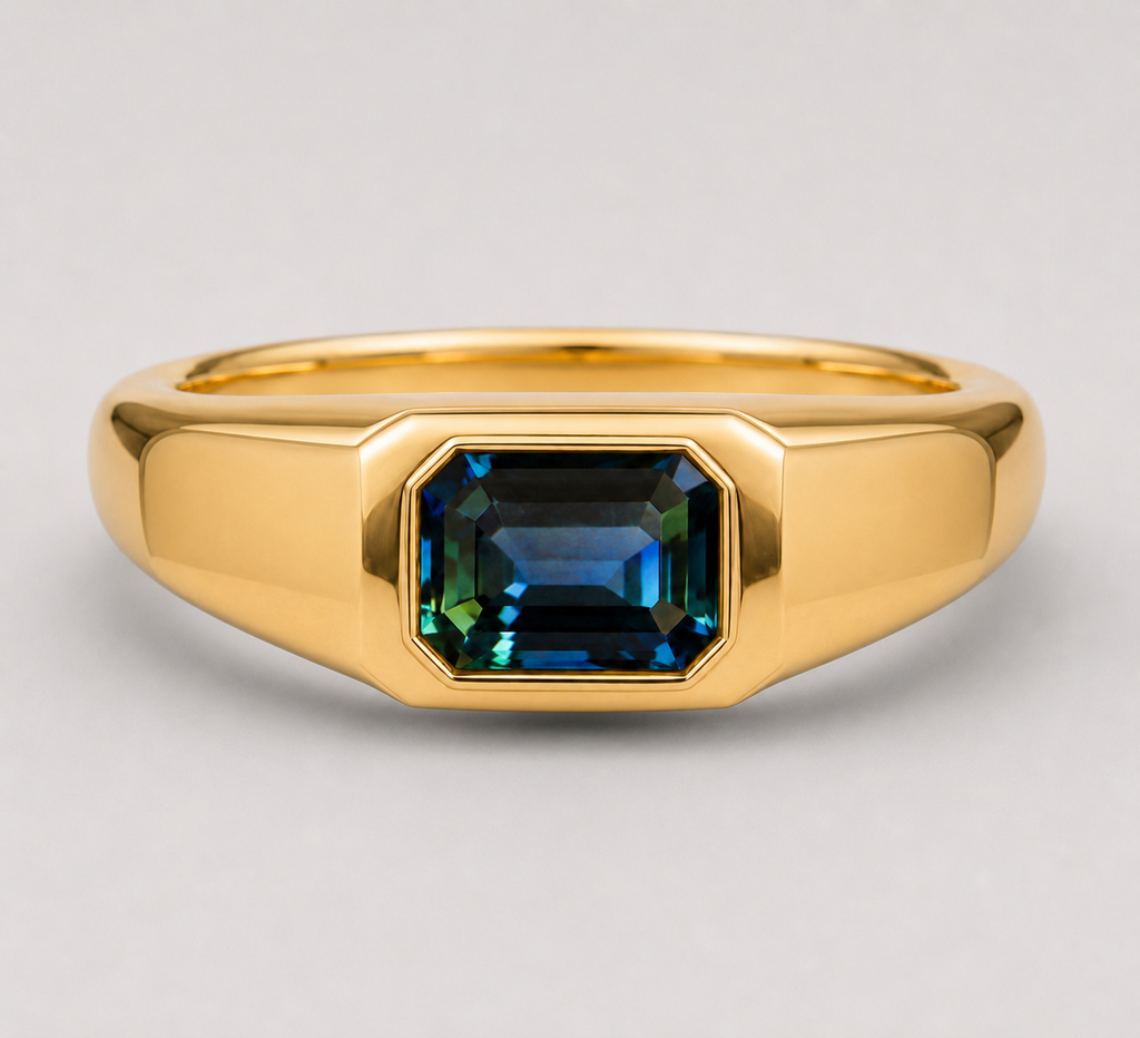 3D render of an emerald cut blue/green parti sapphire flush set in a signet style gold ring