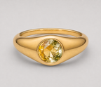 3D render of a signet style bezel set ring with a round bi-coloured yellow sapphire in yellow gold