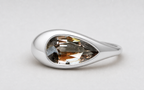 3D render of a pear shaped champagne coloured natural zircon in a sterling silver ornamental ring