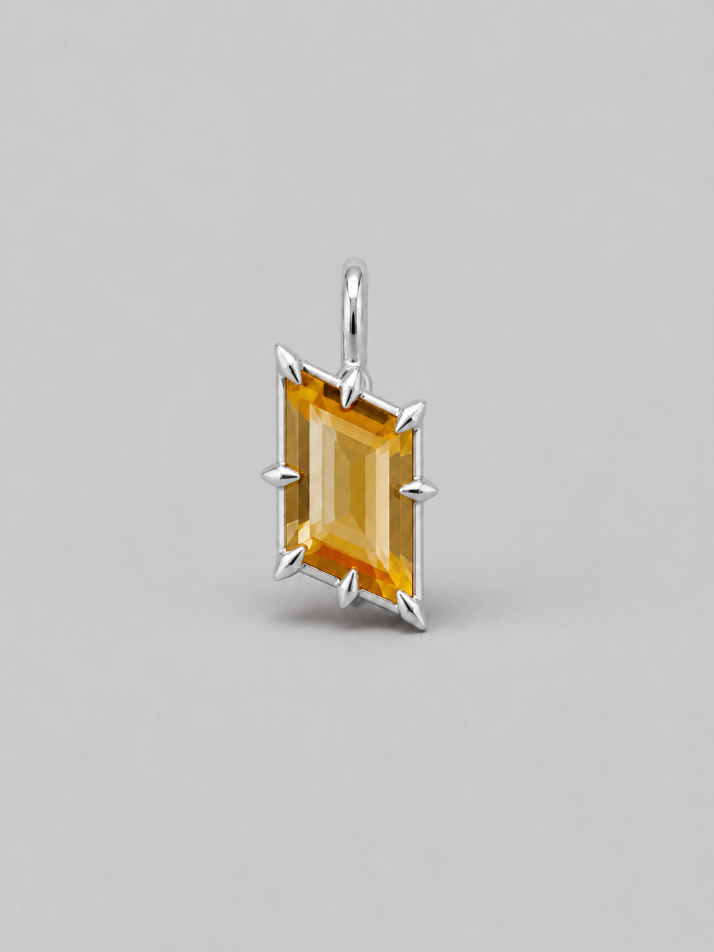 3D render of a silver pendant featuring an rhombus bi-coloured citrine in a multi claw setting, shown on a neutral grey background.