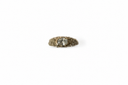 textured gold ring with a white diamond on a white background