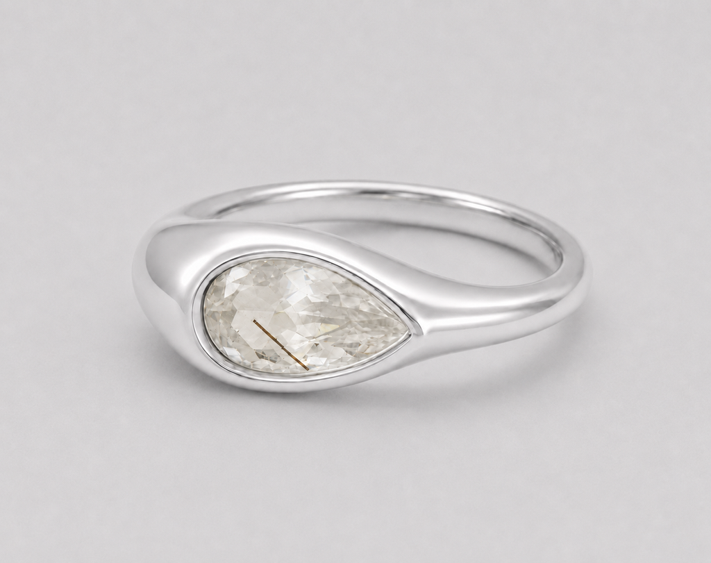 3D render of a golden rutilated white pear shape topaz in a bezel set sterling silver ring