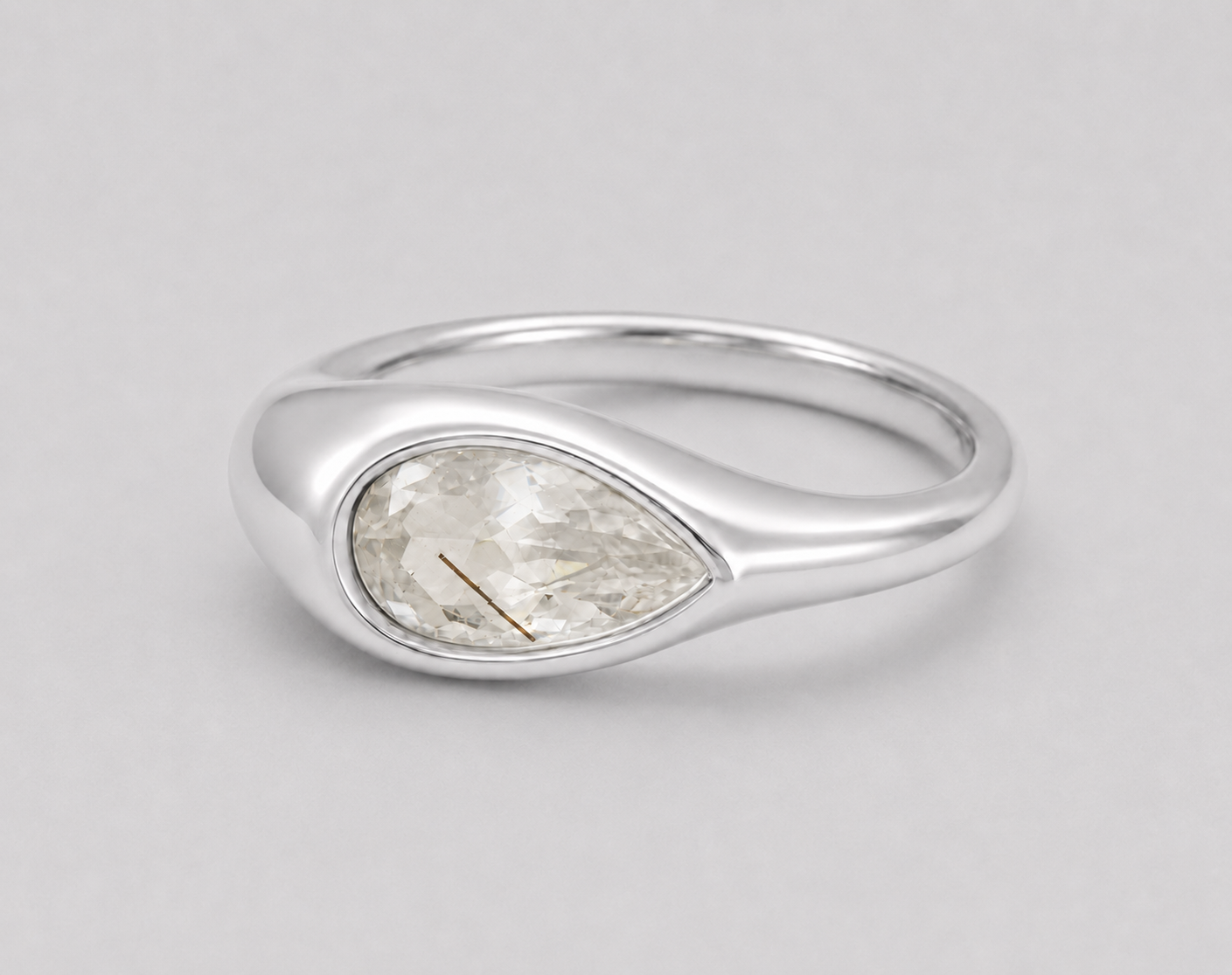 3D render of a golden rutilated white pear shape topaz in a bezel set sterling silver ring