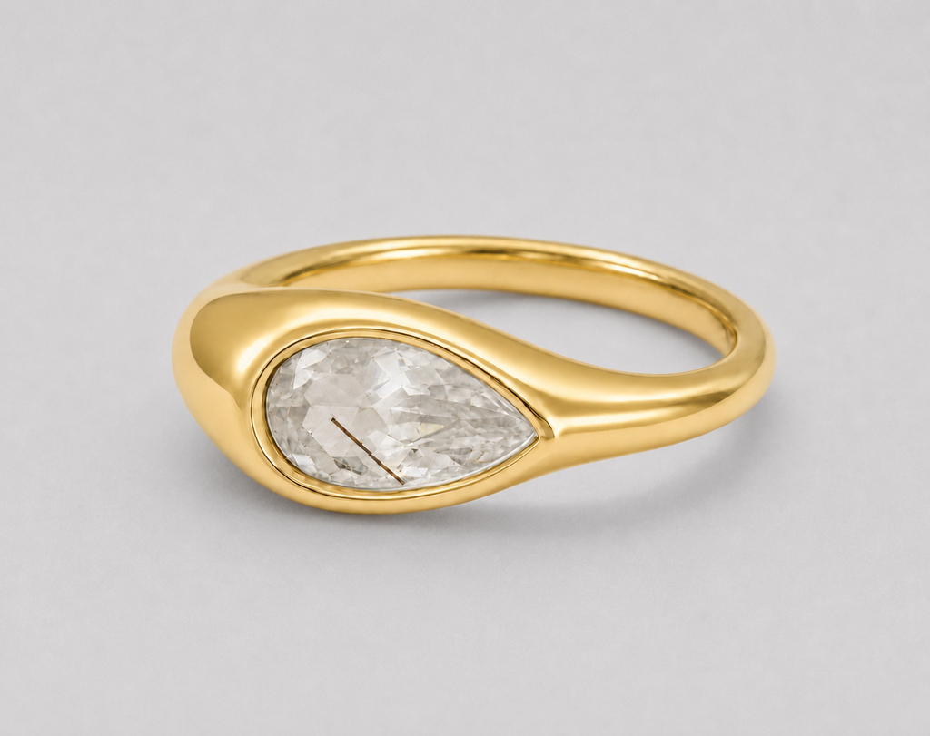 3D render of a golden rutilated white pear shape topaz in a bezel set yellow gold ring