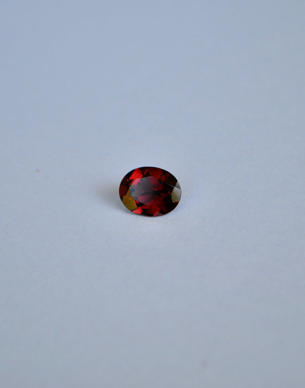 A loose oval deep red almandine garnet gemstone