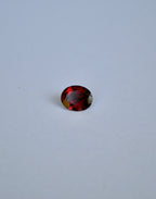 A loose oval deep red almandine garnet gemstone
