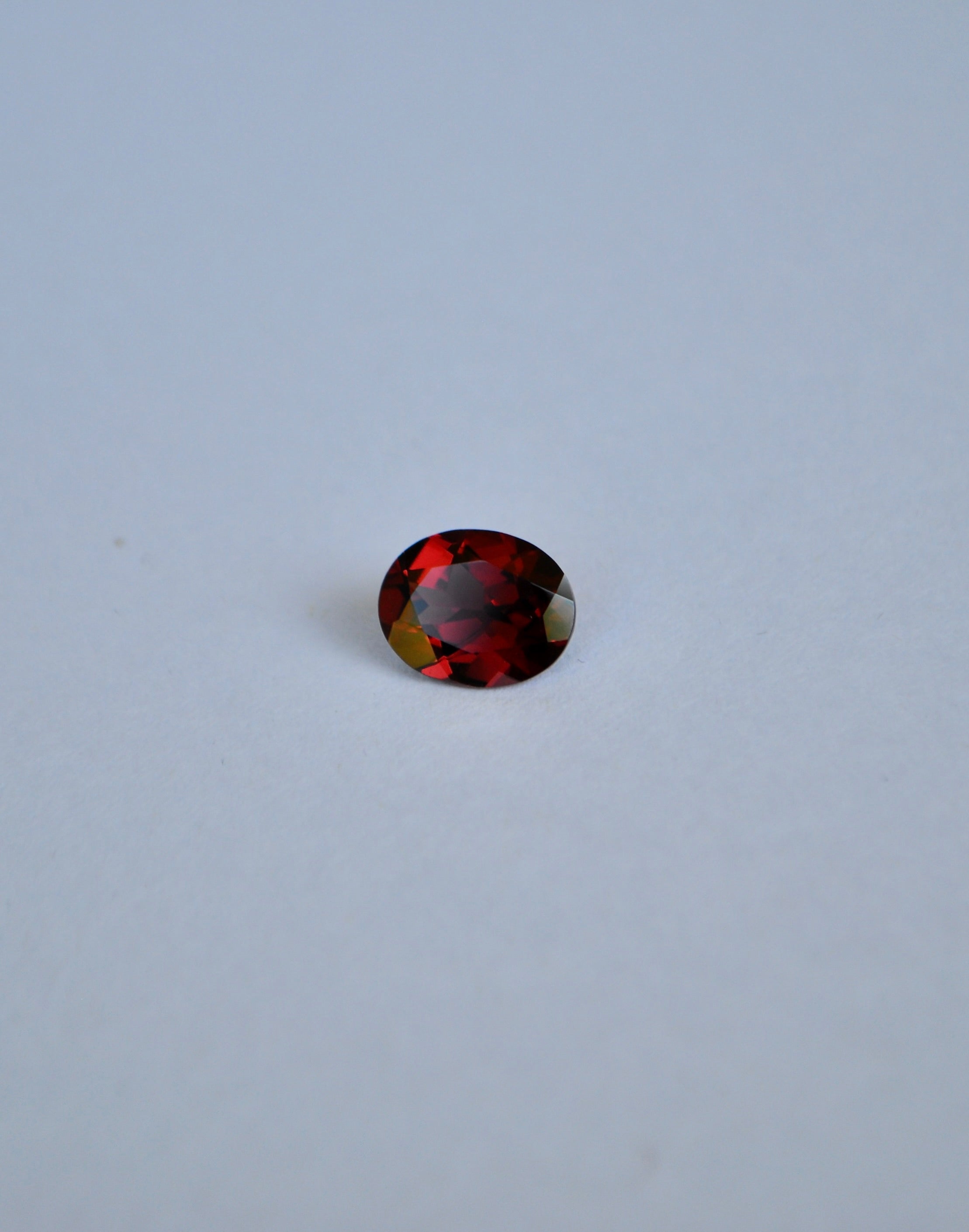 A loose oval deep red almandine garnet gemstone