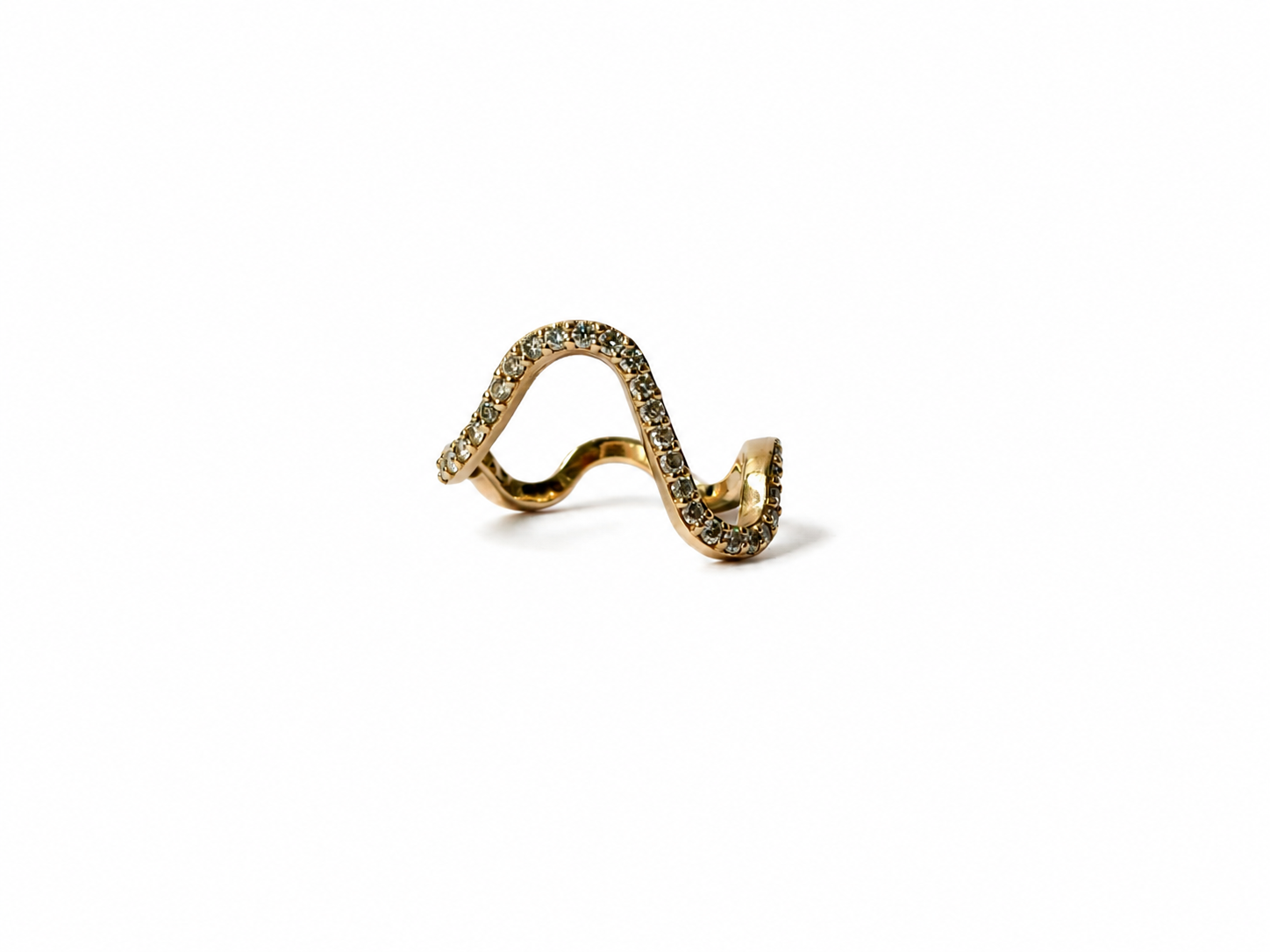 Gold wavy pavé diamond ring on a white background