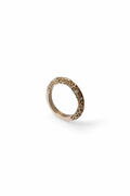 A single textured knife edge ring in a warm gold metal, photographed on a clean white background with a soft shadow.