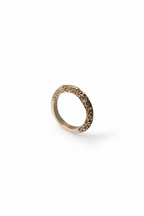 A single textured knife edge ring in a warm gold metal, photographed on a clean white background with a soft shadow.