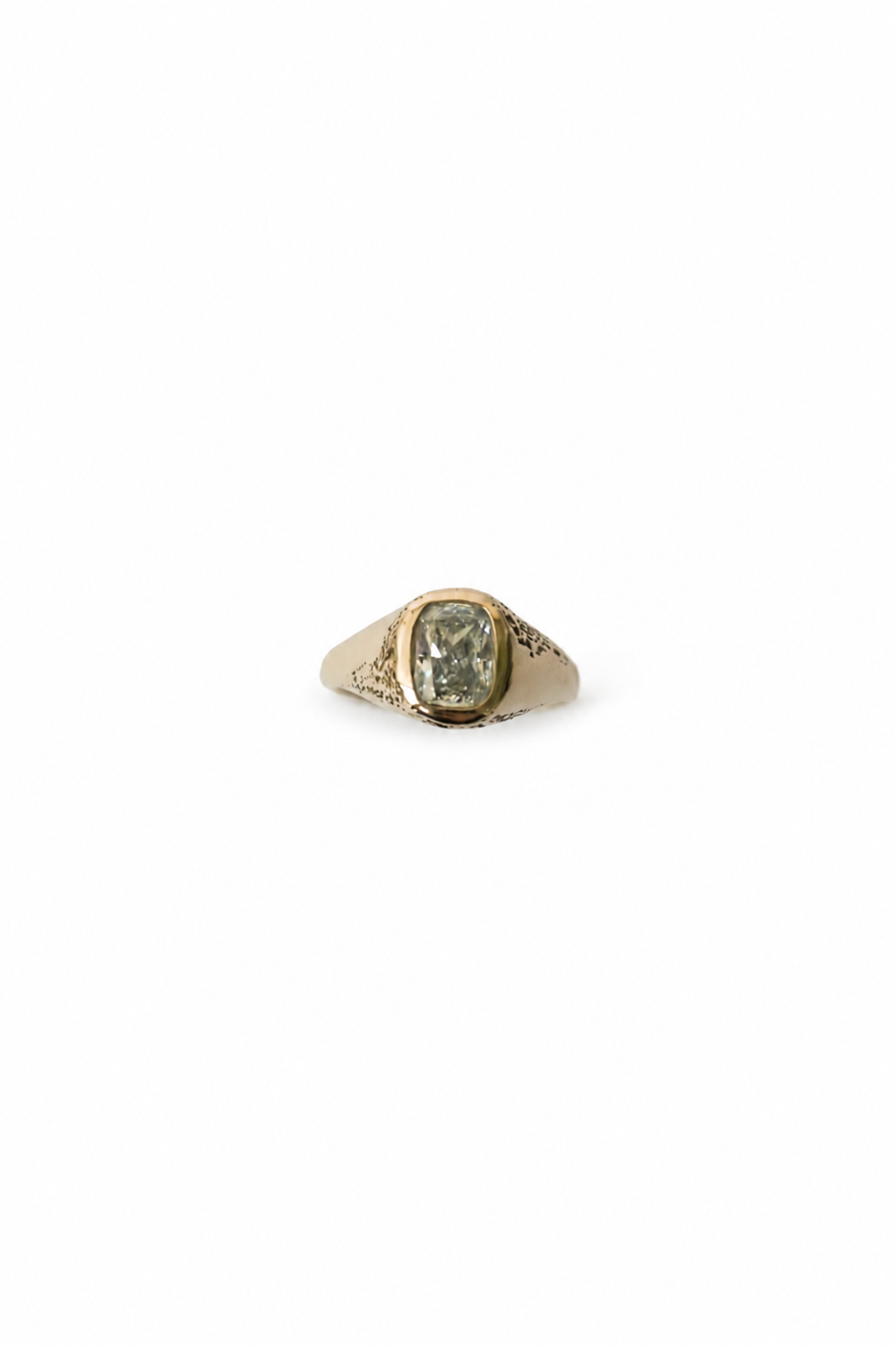 A vintage-style signet ring with a gold-toned band and a rectangular silver diamond on a plain white background.