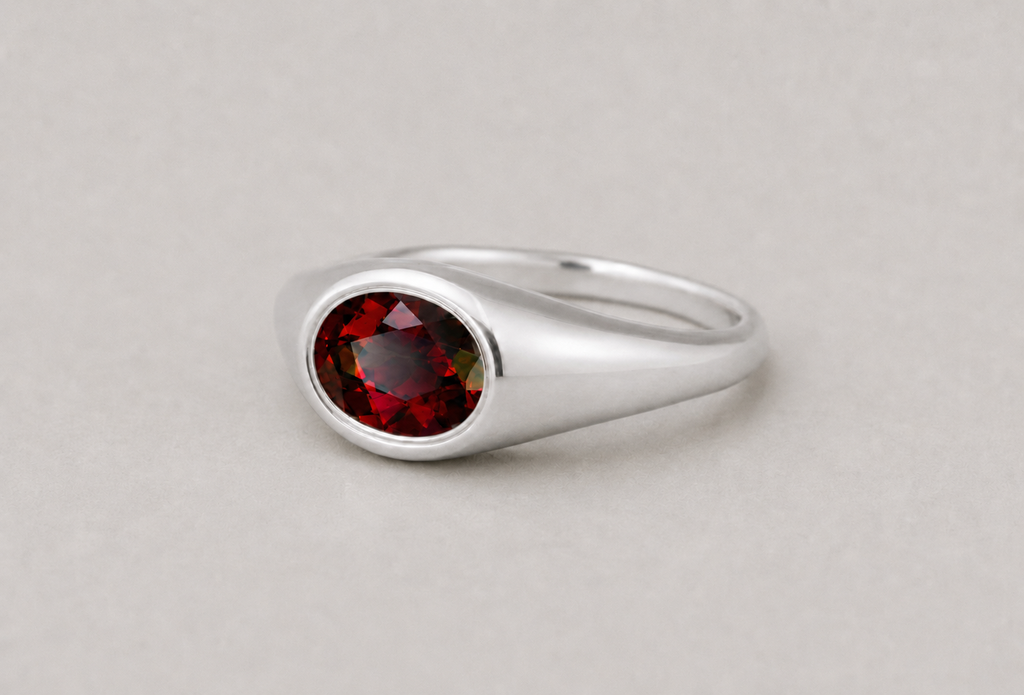 3D render of a deep red almandine garnet bezel set in a sterling silver signet ring
