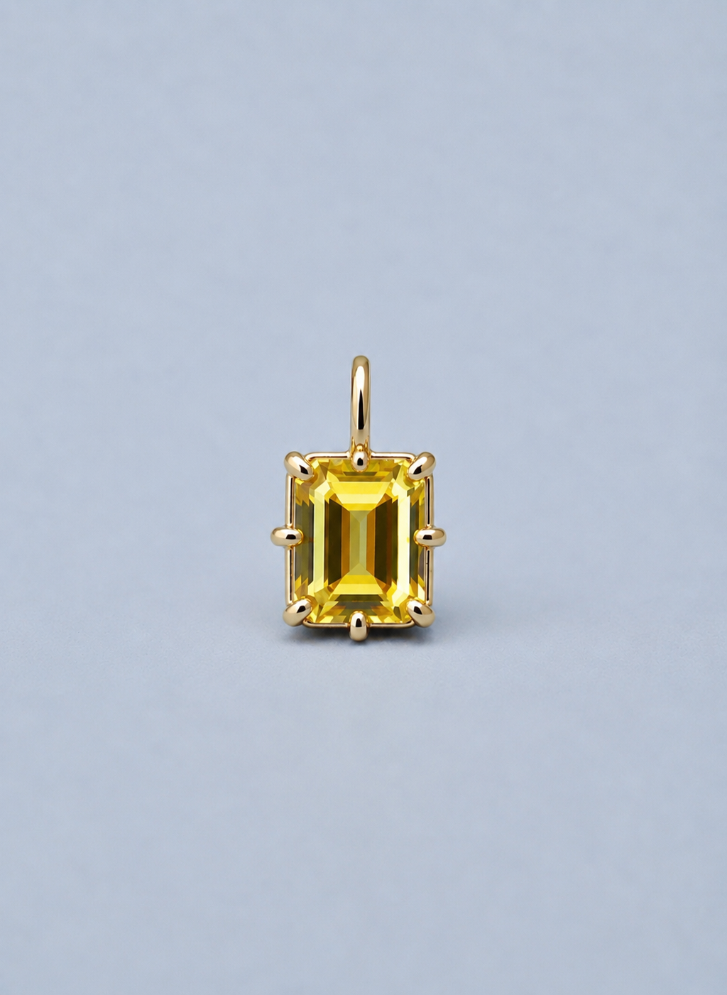 3D render of an emerald cut yellow Australian sapphire in a gold multi claw pendant setting 
