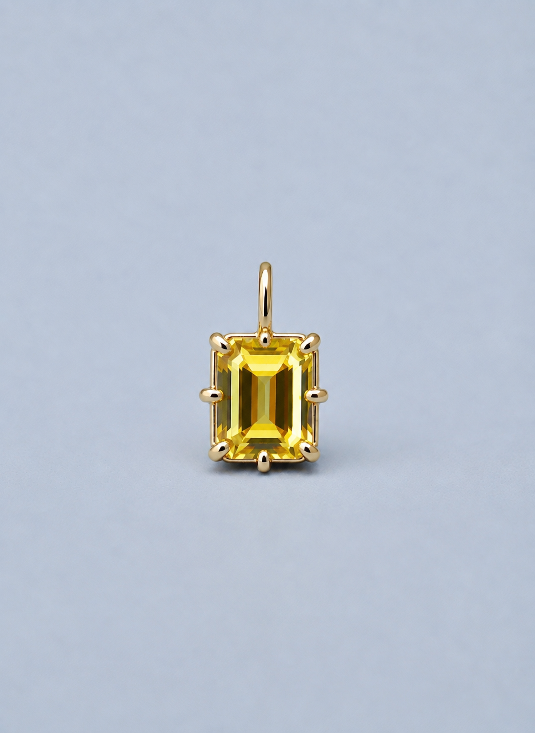 3D render of an emerald cut yellow Australian sapphire in a gold multi claw pendant setting 