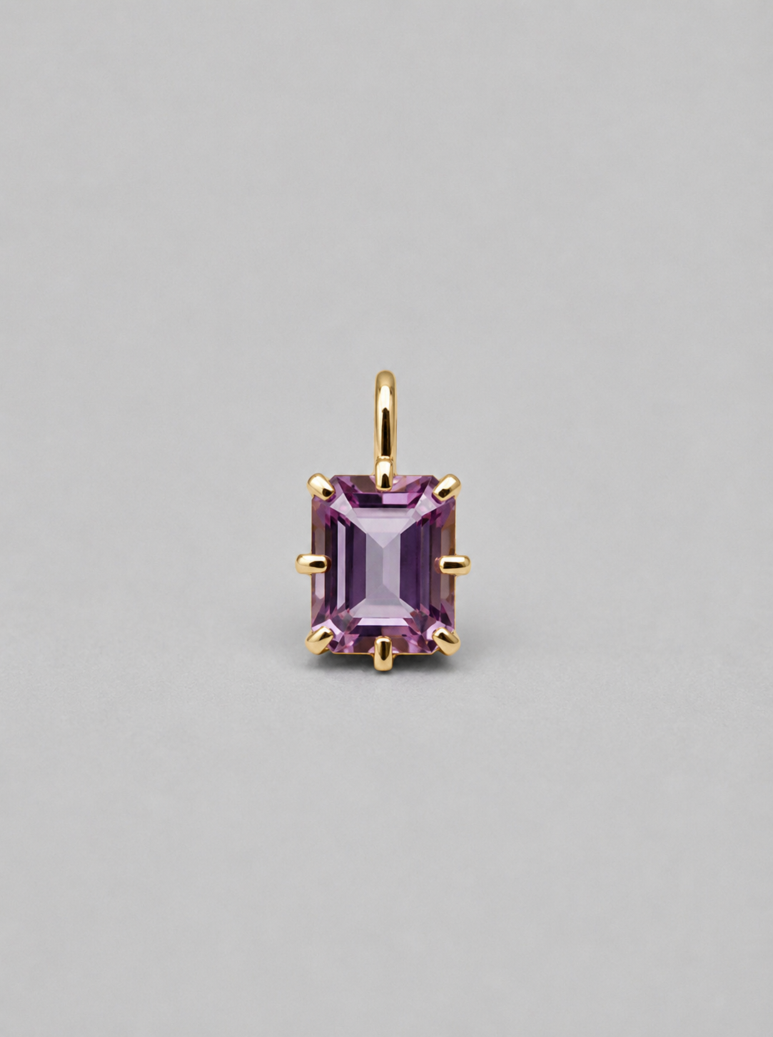 3D render of a gold  multi claw pendant featuring an emerald cut purple spinel 