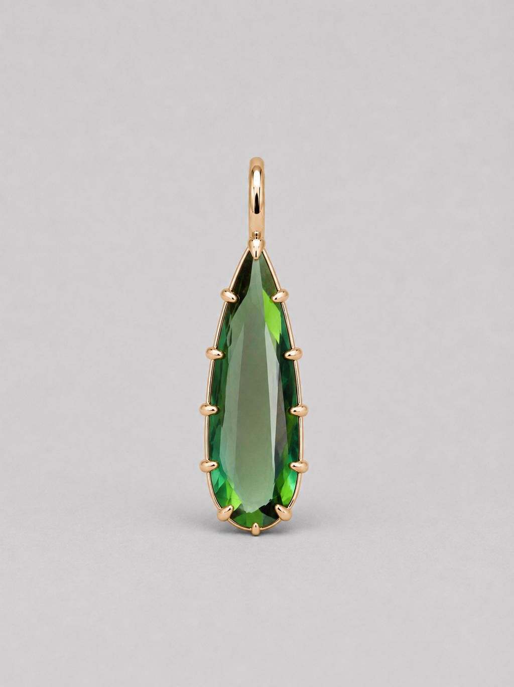 3d render of an elongated pear shape dark green tourmaline set in a yellow gold multi claw pendant