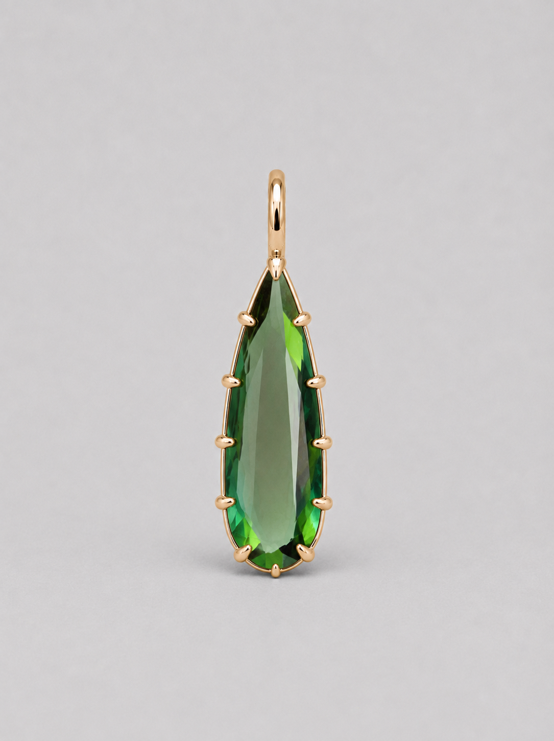 3d render of an elongated pear shape dark green tourmaline set in a yellow gold multi claw pendant