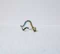 A silver wavy pavé ring adorned with green gemstones, photographed on a plain white background.