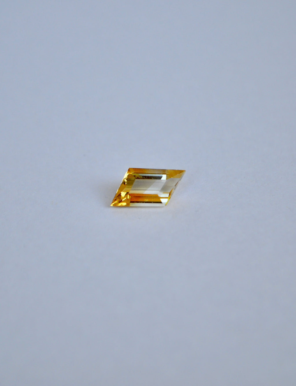 Rhombus bi-colour citrine on a light grey background