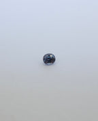 Oval brilliant cut colour chance loose sapphire on white background. Blue/purple in fluorescent light