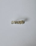 A silver ring with a textured band and a central champagne zircon shown on a plain light grey background.